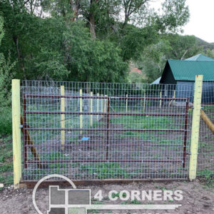 Six foot tall, “Max -Tight Wire” fence with pressure treated wood posts. Metal framework gates with 2” x 4” utility steel mesh and horseshoe drop fork gate latches. Works well for young children, pets & keeping your garden safe from animals. <br/>© Copyright 4 Corners Fencing, llc