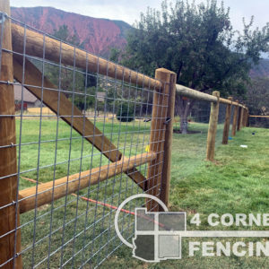 Single rail, pressure treated, dowelled pole, jumbo size, (4 – 5″ Dia. rails & 6” Dia. posts) with 48” tall welded steel wire. <br/>© Copyright 4 Corners Fencing, llc